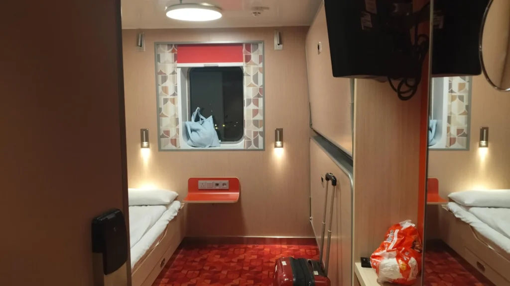 Zo ziet je hut er uit op de veerboot. 4 stapelbedden - een raampje, kleine badkamer.